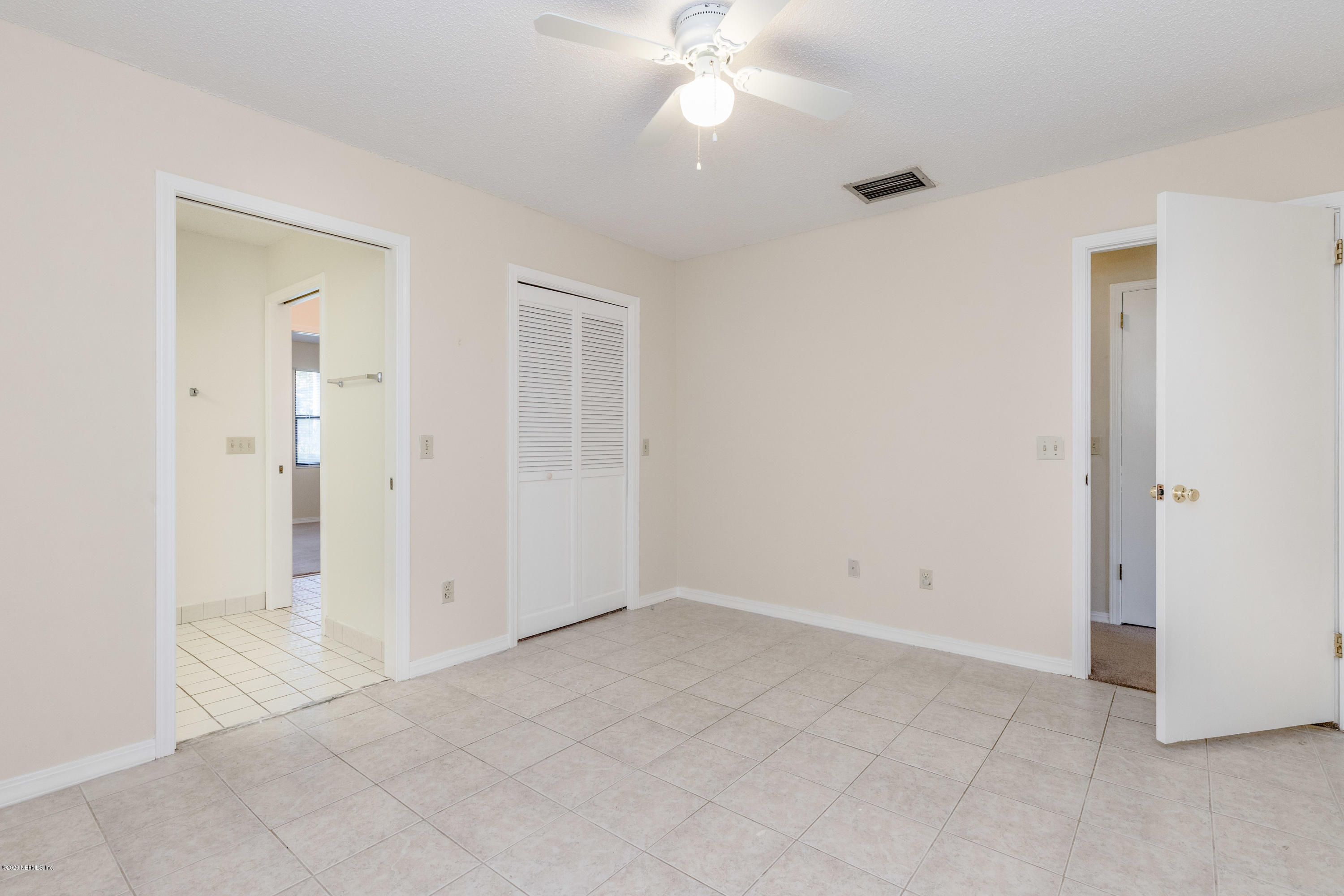 1704 Memory Lane Jacksonville, FL 32210 - Photo 19 of 54 an empty room with fan and entrance