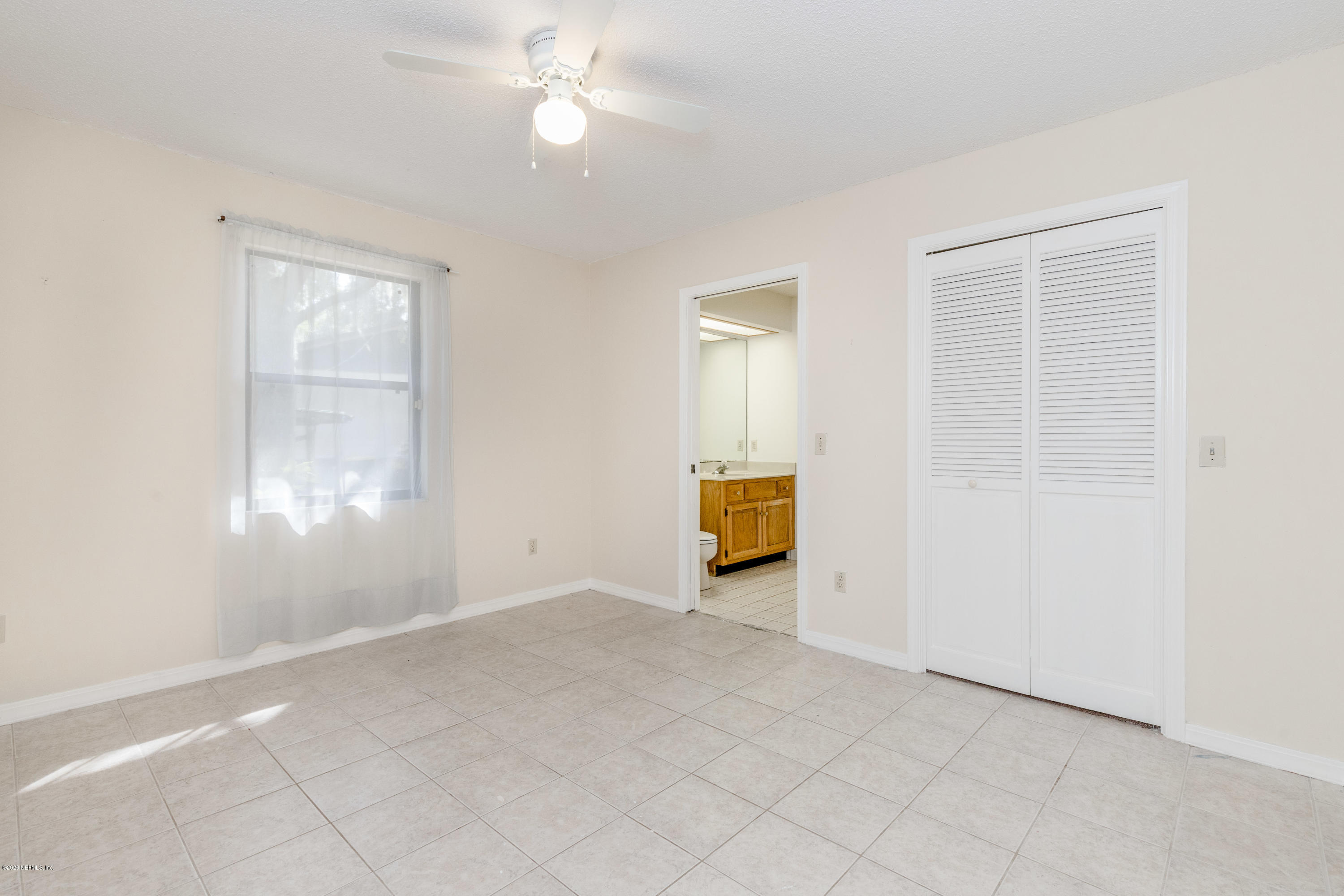 1704 Memory Lane Jacksonville, FL 32210 - Photo 20 of 54 an empty room with a ceiling fan and a window