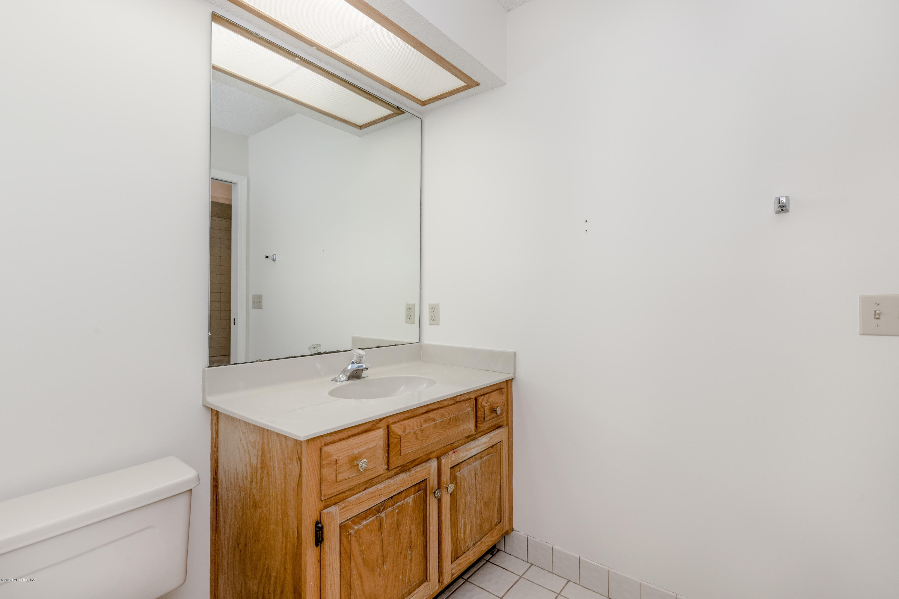 1704 Memory Lane Jacksonville, FL 32210 - Photo 21 of 54 a utility room with a sink a toilet and mirror