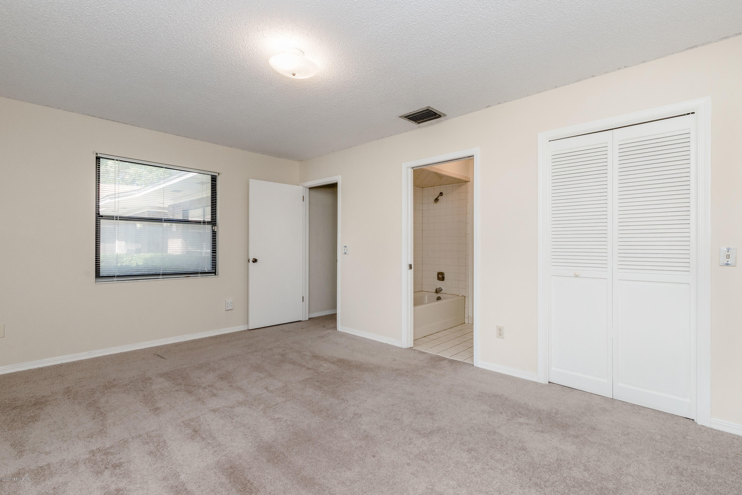 1704 Memory Lane Jacksonville, FL 32210 - Photo 23 of 54 an empty room with windows and closet