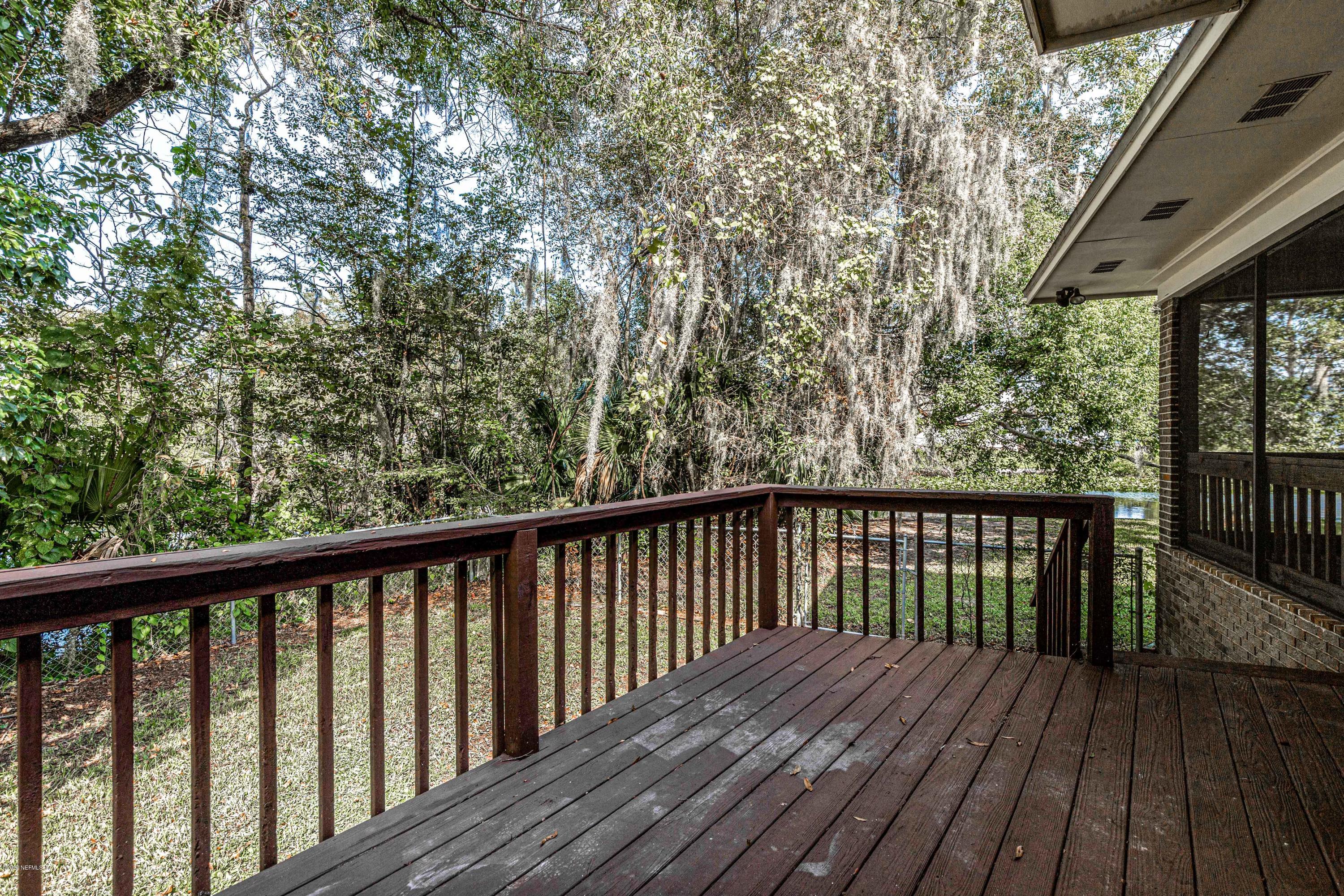 1704 Memory Lane Jacksonville, FL 32210 - Photo 29 of 54 a balcony with wooden floor and fence