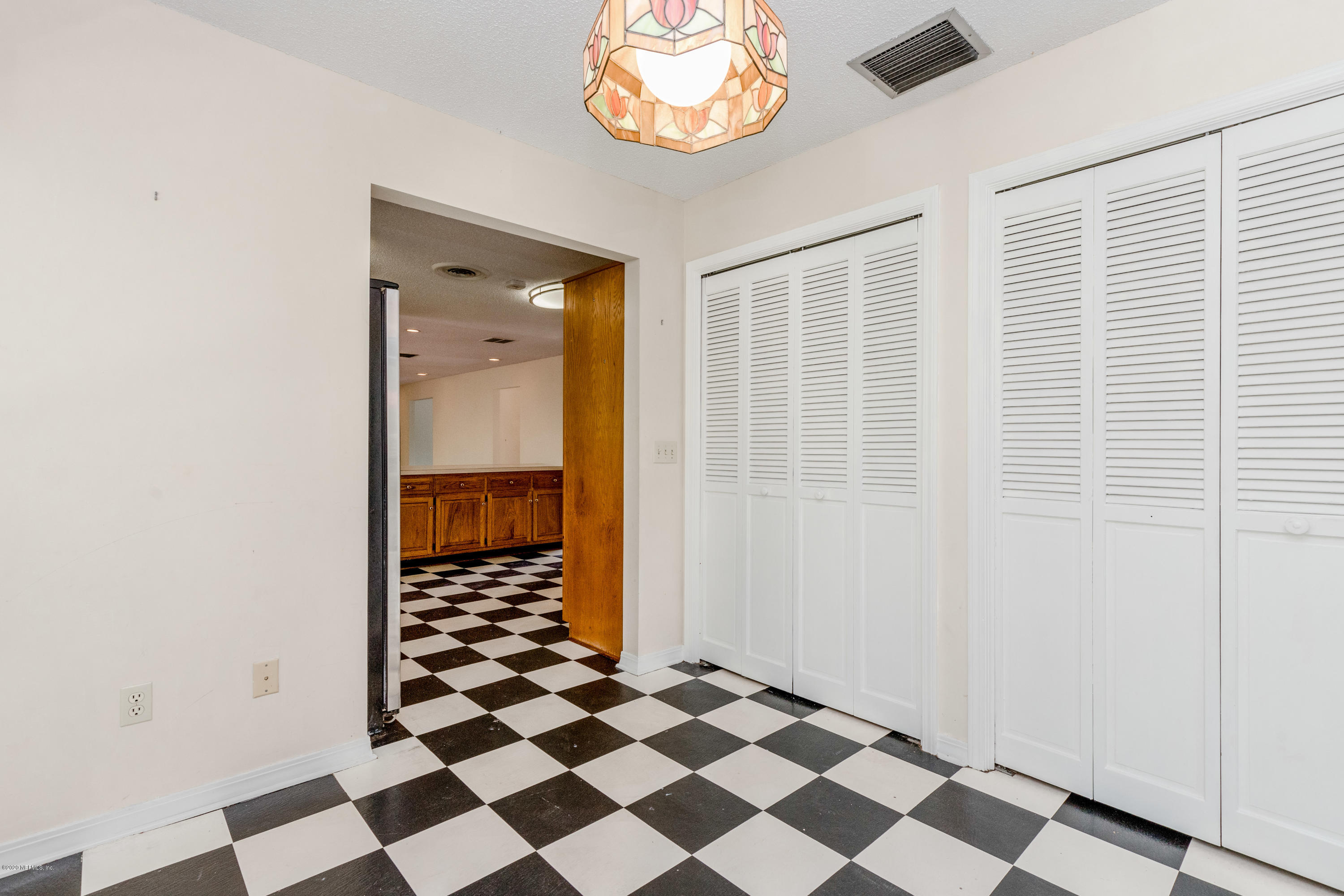 1704 Memory Lane Jacksonville, FL 32210 - Photo 40 of 54 a view of a big room with a black white checkered floor and a dining table