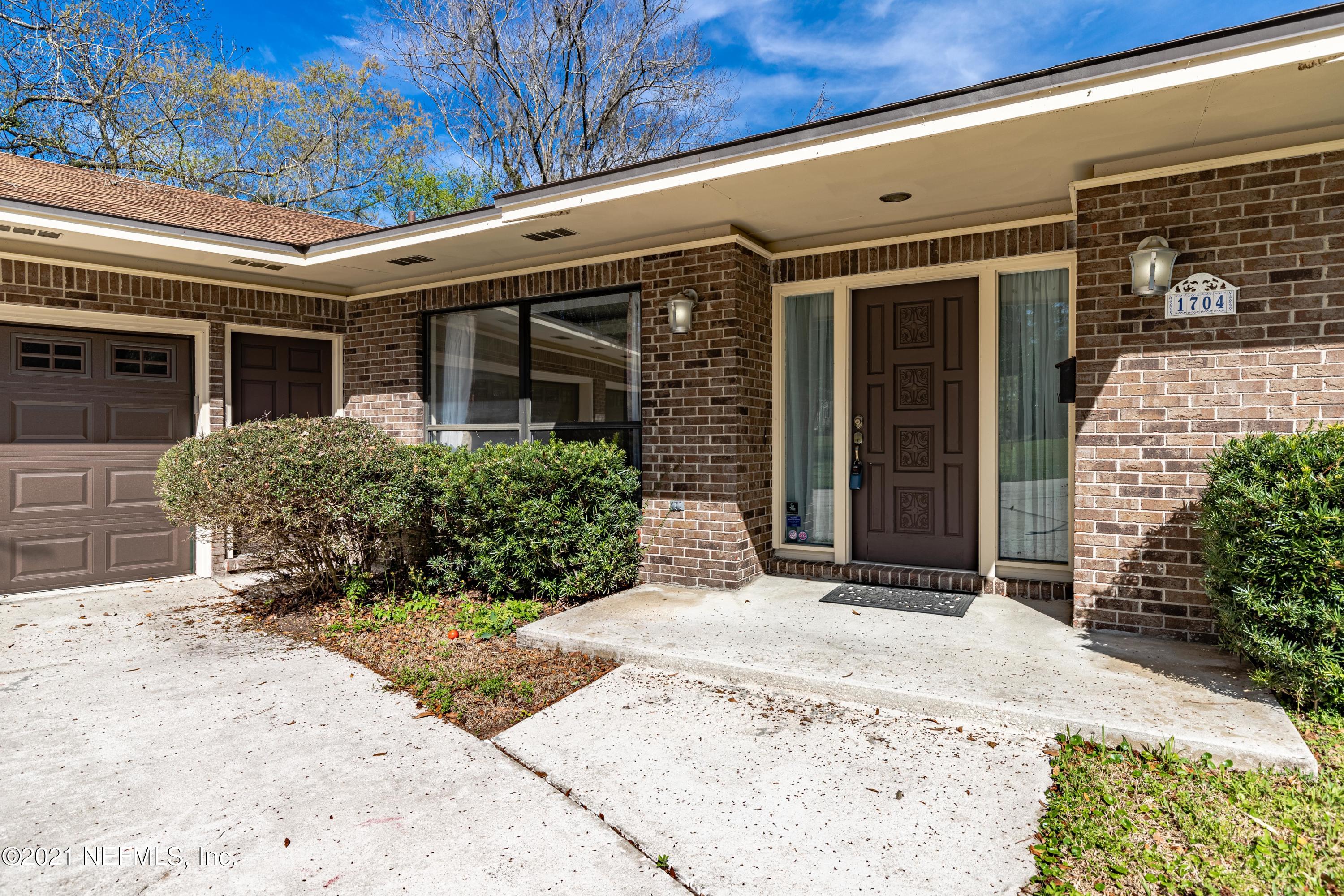 1704 Memory Lane Jacksonville, FL 32210 - Photo 4 of 54 front view of a brick house with potted plants