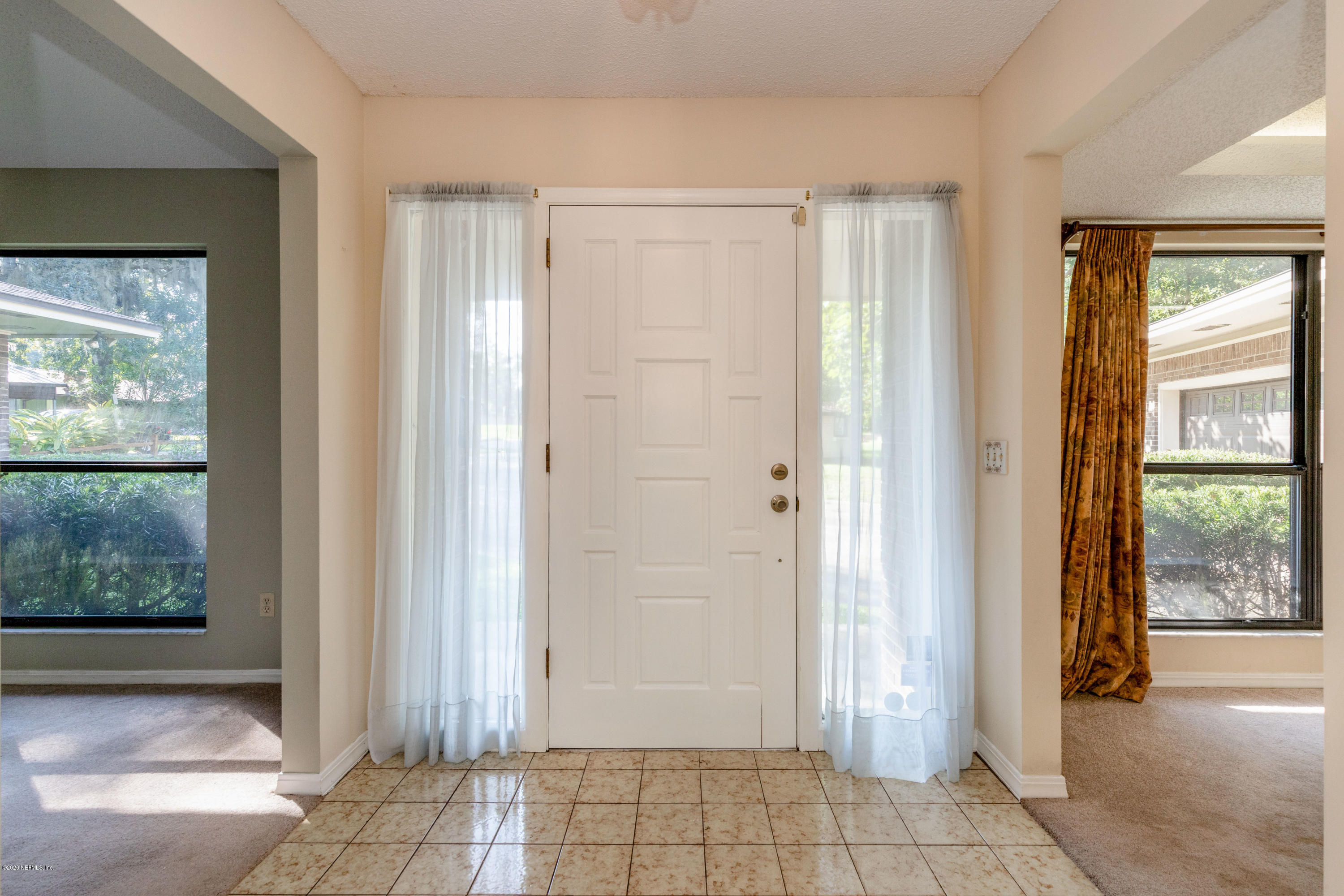 1704 Memory Lane Jacksonville, FL 32210 - Photo 43 of 54 a view of an entryway with wooden floor and a livingroom