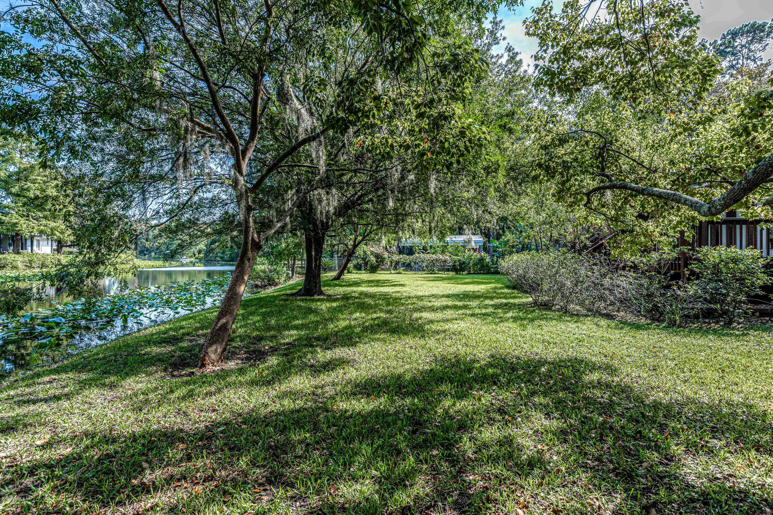 1704 Memory Lane Jacksonville, FL 32210 - Photo 48 of 54 a view of a green field with lots of bushes
