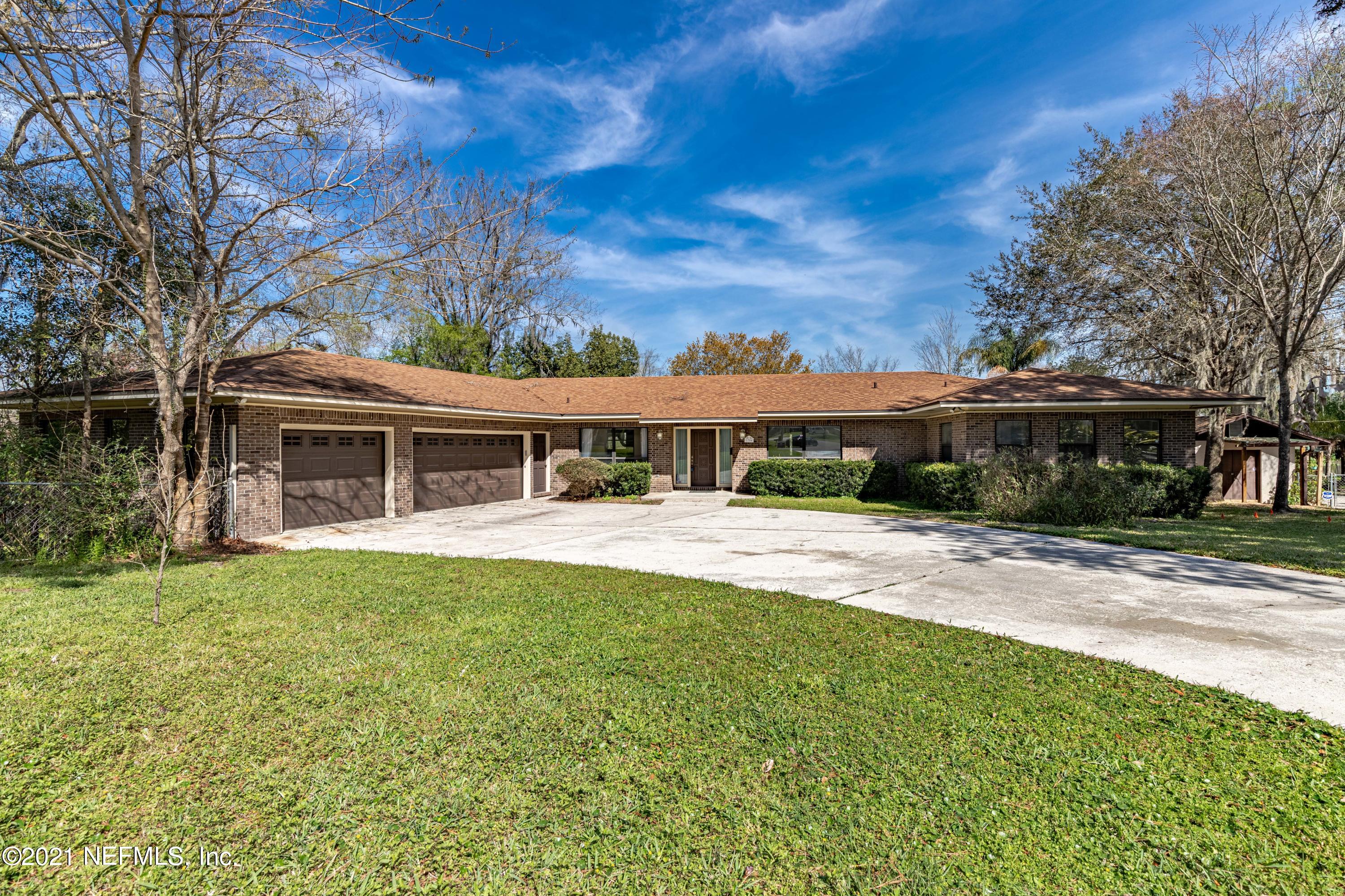 1704 Memory Lane Jacksonville, FL 32210 - Photo 51 of 54 a front view of house with yard and trees in the background