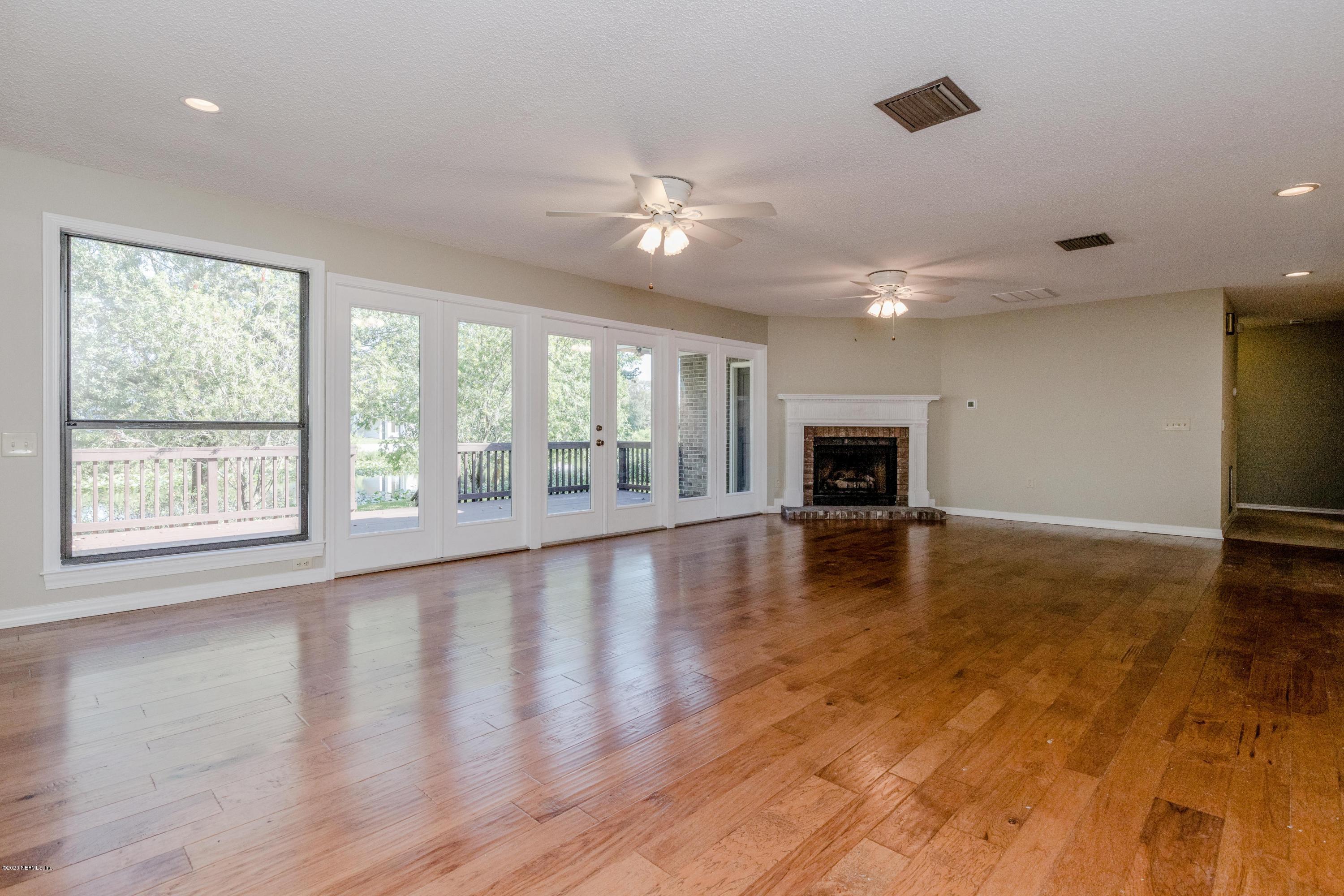 1704 Memory Lane Jacksonville, FL 32210 - Photo 6 of 54 a view of empty room with wooden floor and fireplace