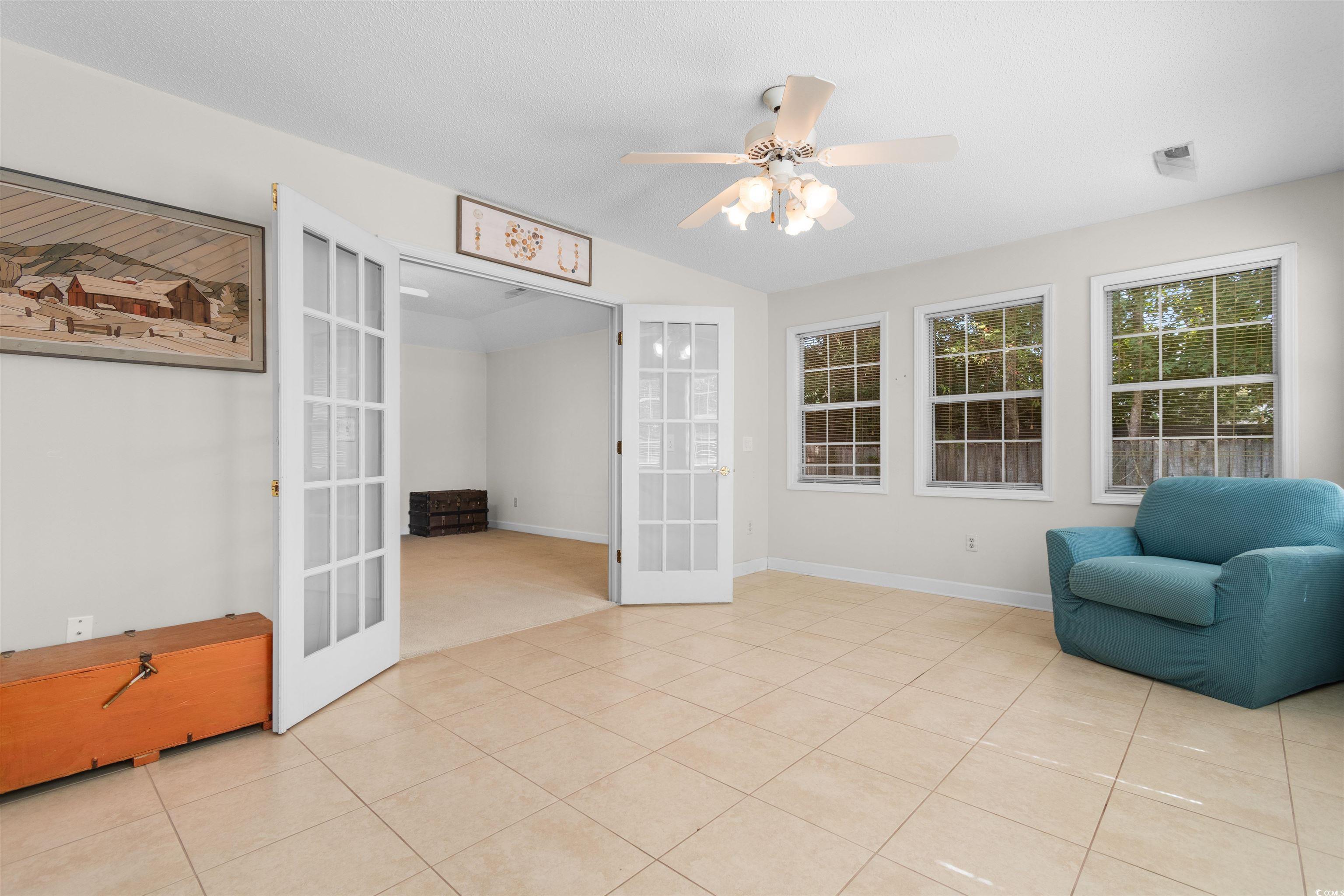 203 Prestwick Road Myrtle Beach, SC 29588 - Photo 17 of 34 Carpeted spare room with ceiling fan, vaulted ceil