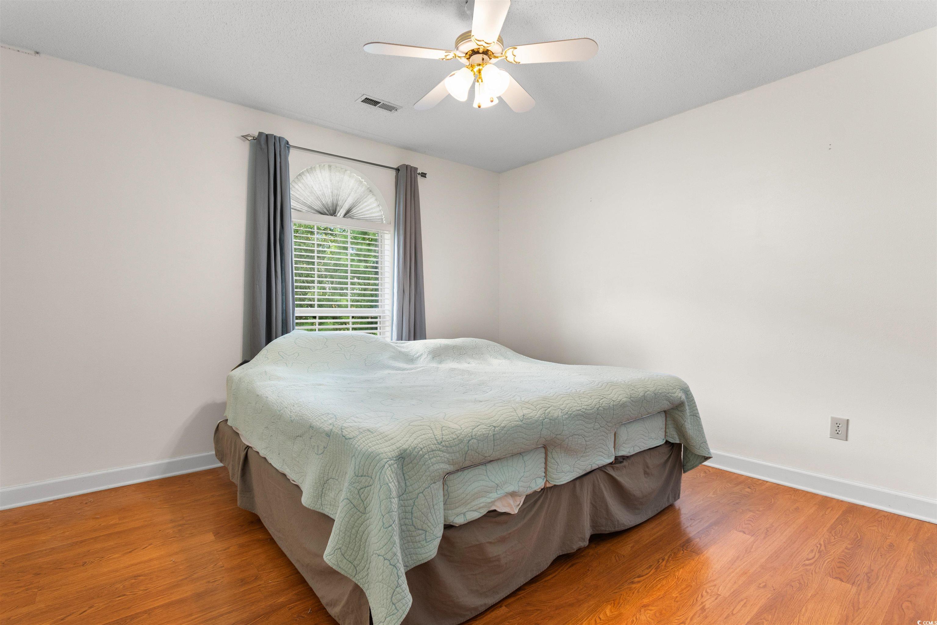 203 Prestwick Road Myrtle Beach, SC 29588 - Photo 20 of 34 Bedroom with ceiling fan and light hardwood / wood
