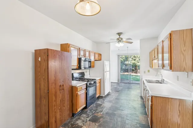 a kitchen with stainless steel appliances a refrigerator and a stove
