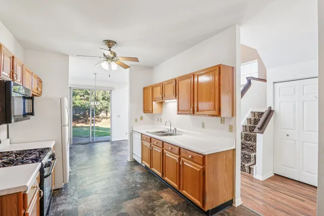 a bathroom with a granite countertop sink a mirror a vanity and a bathtub
