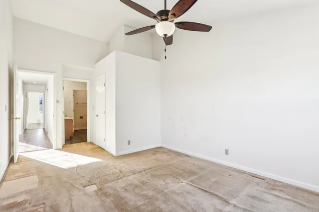 a view of a room with a ceiling fan