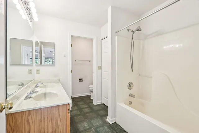 a bathroom with a sink mirror toilet and bathtub