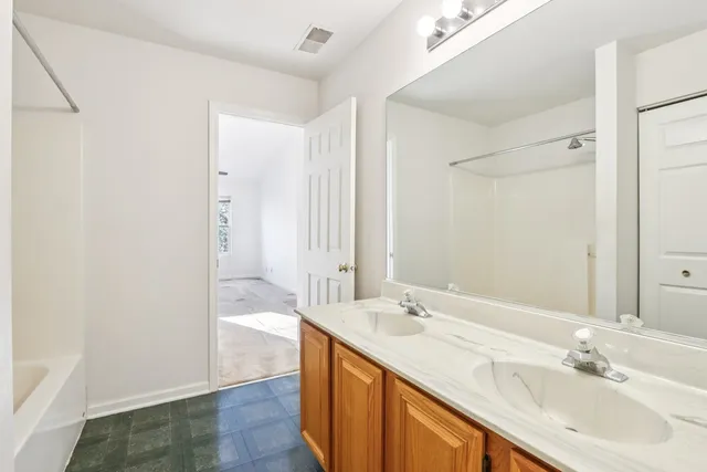 a bathroom with a sink double vanity and a bathtub