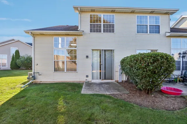 a view of a house with backyard and a garden