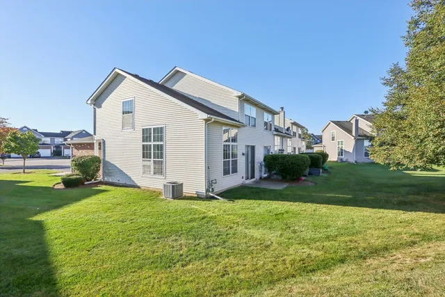 a view of a house with a yard and pathway
