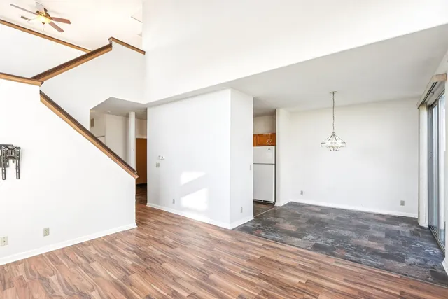 a view of a room with wooden floor and white walls