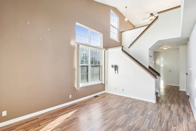 a view of entryway with wooden floor and stairs