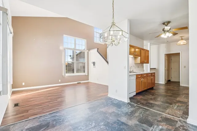 a view of a kitchen with granite countertop natural light wood floor and a window