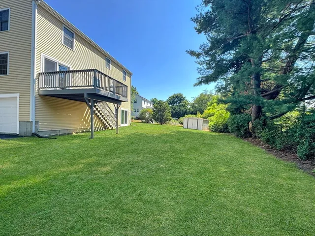 a view of a house with backyard and garden