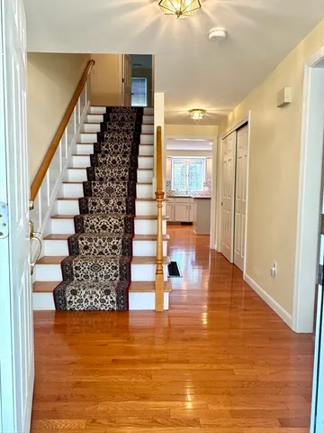a view of entryway and hall with wooden floor