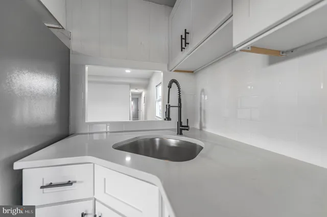 a kitchen with a sink and cabinets