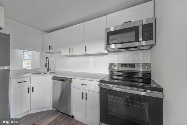 a kitchen with a stove and a microwave