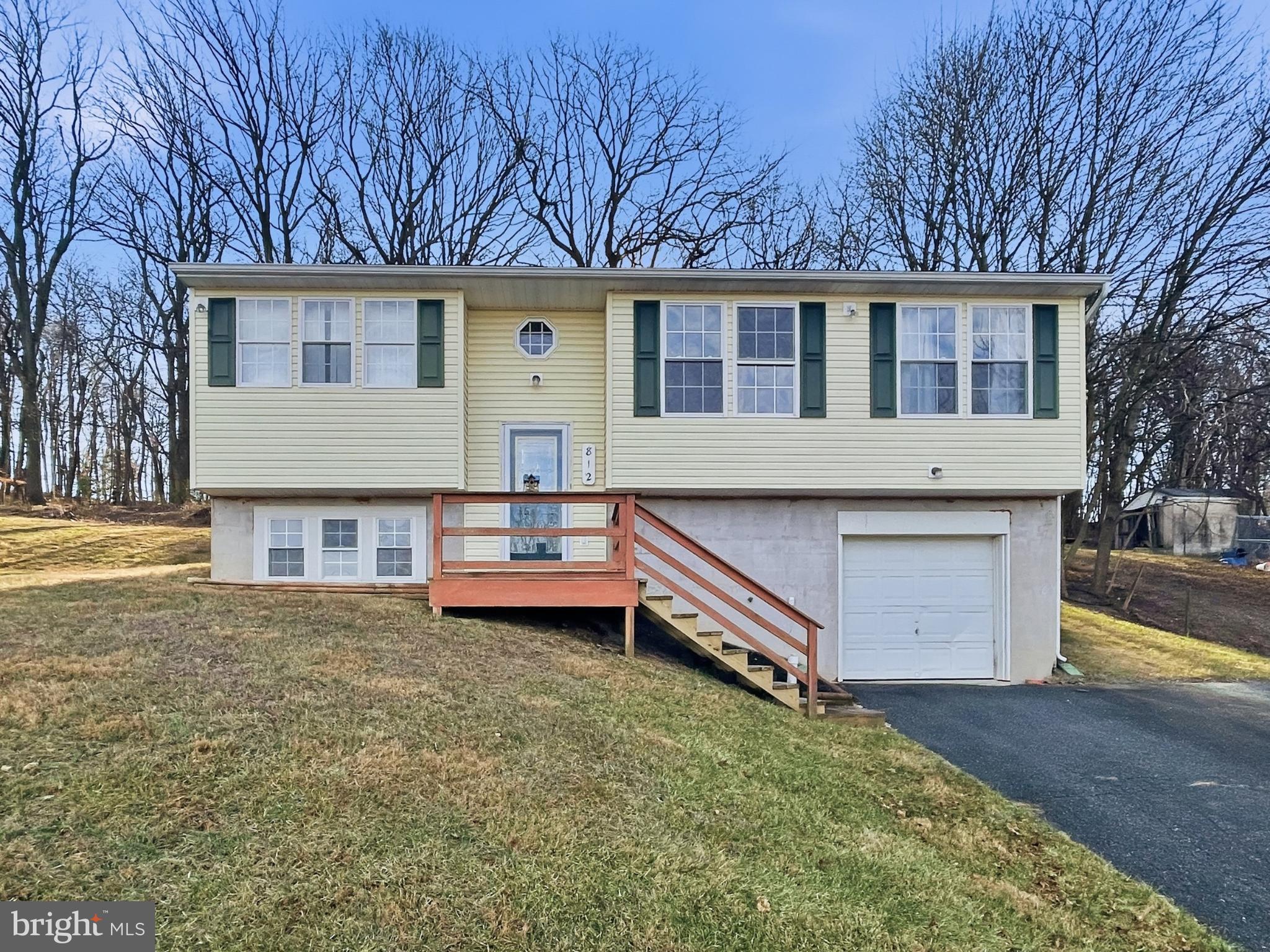 front view of house with a yard and wooden fence