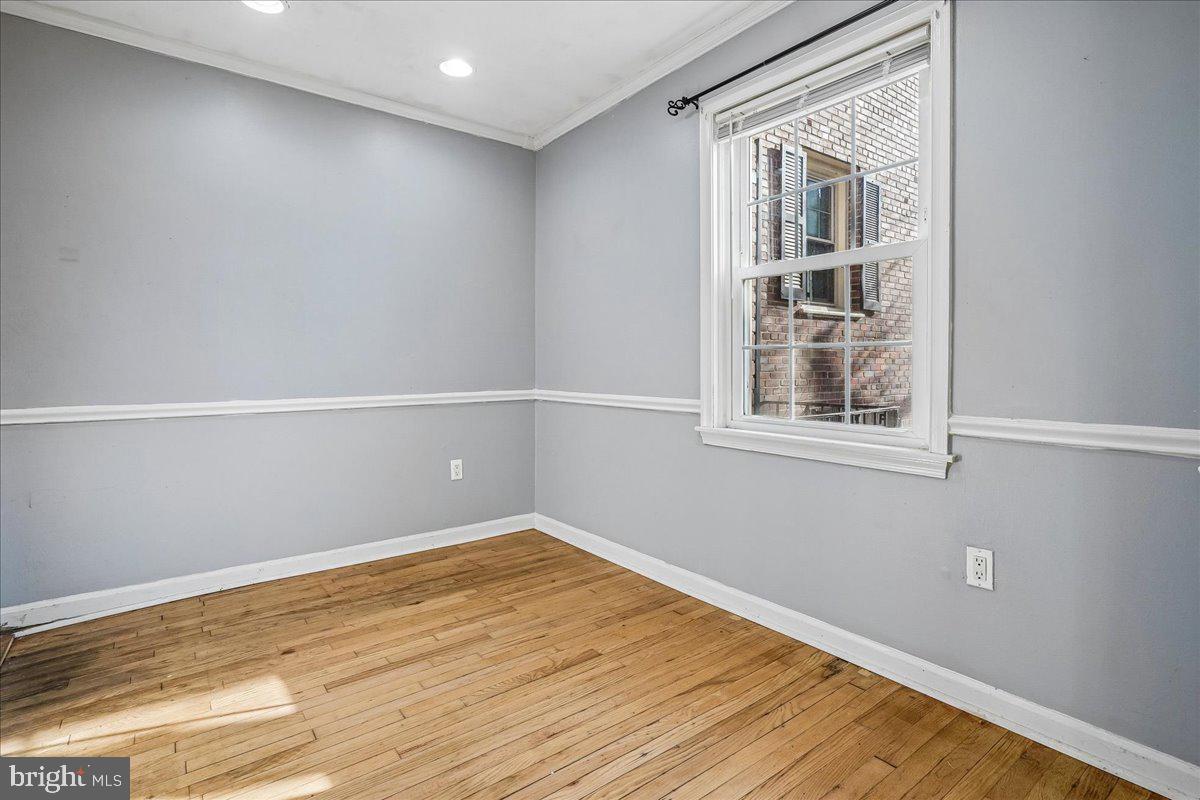 2015 38th Street Southeast, Unit B Washington, DC 20020 - Photo 11 of 30 a view of empty room with wooden floor and fan