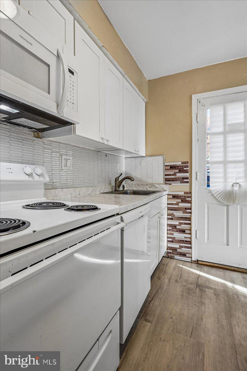 2015 38th Street Southeast, Unit B Washington, DC 20020 - Photo 14 of 30 a kitchen with granite countertop a sink and cabinets