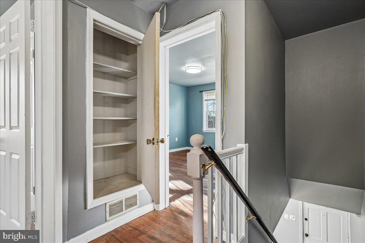 2015 38th Street Southeast, Unit B Washington, DC 20020 - Photo 18 of 30 a view of a hallway with wooden floor and stairs