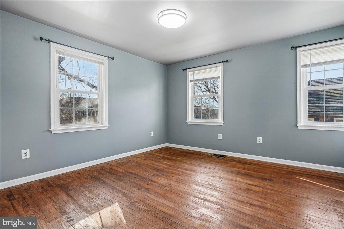 2015 38th Street Southeast, Unit B Washington, DC 20020 - Photo 19 of 30 a view of an empty room with wooden floor and a window