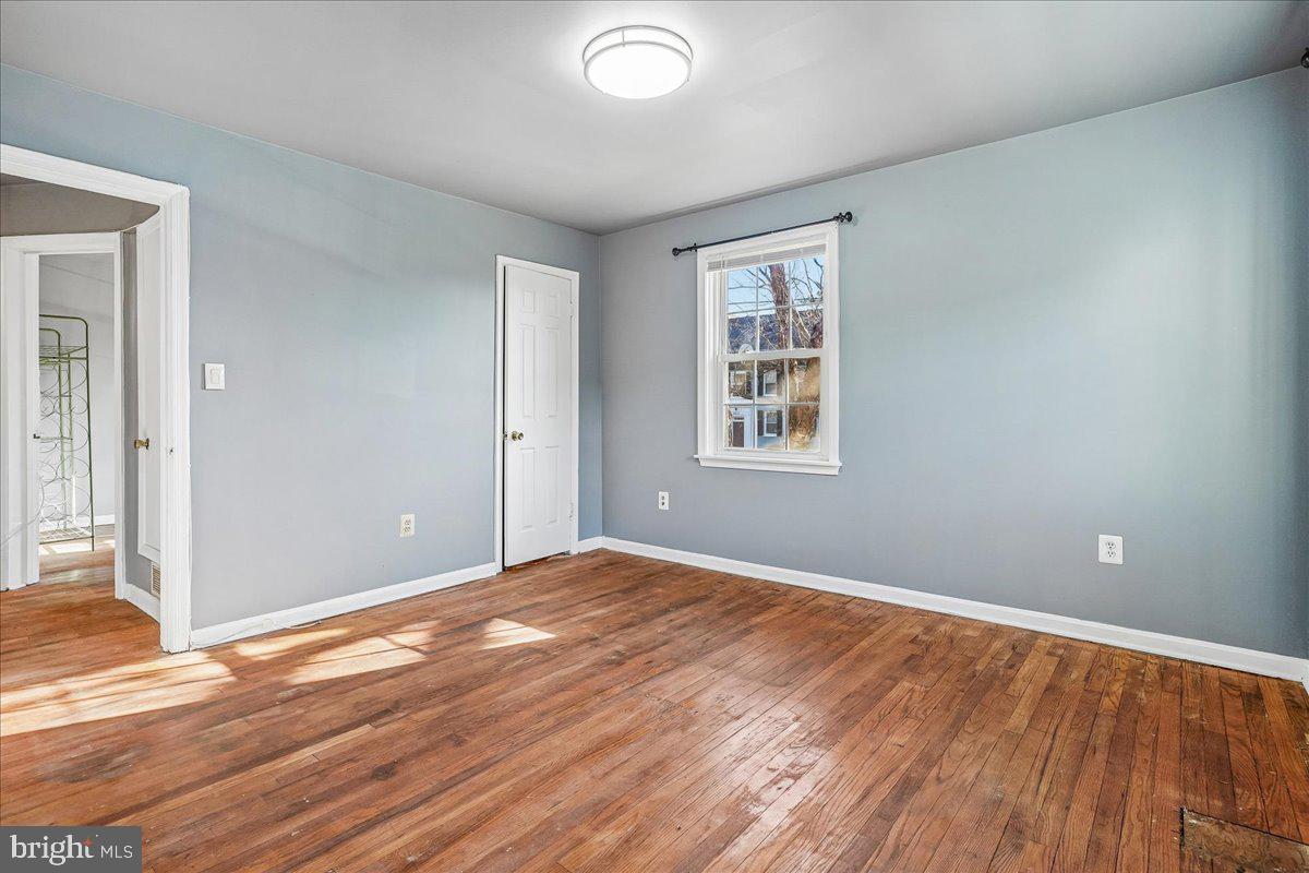 2015 38th Street Southeast, Unit B Washington, DC 20020 - Photo 21 of 30 a view of an empty room with wooden floor and a window