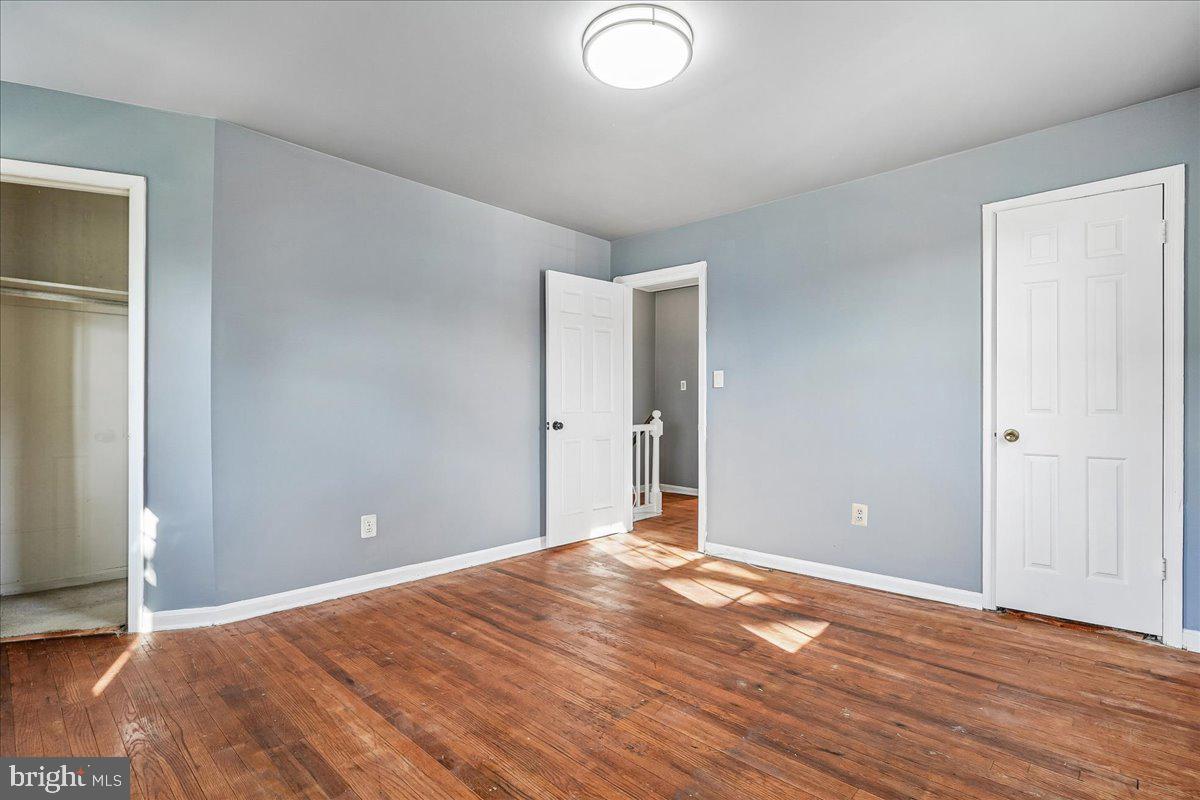 2015 38th Street Southeast, Unit B Washington, DC 20020 - Photo 22 of 30 an empty room with wooden floor and windows