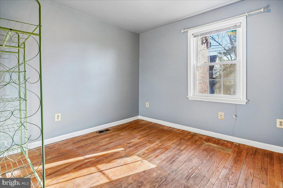 2015 38th Street Southeast, Unit B Washington, DC 20020 - Photo 25 of 30 a view of an empty room with wooden floor and a window