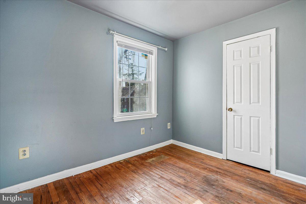 2015 38th Street Southeast, Unit B Washington, DC 20020 - Photo 27 of 30 an empty room with wooden floor and windows