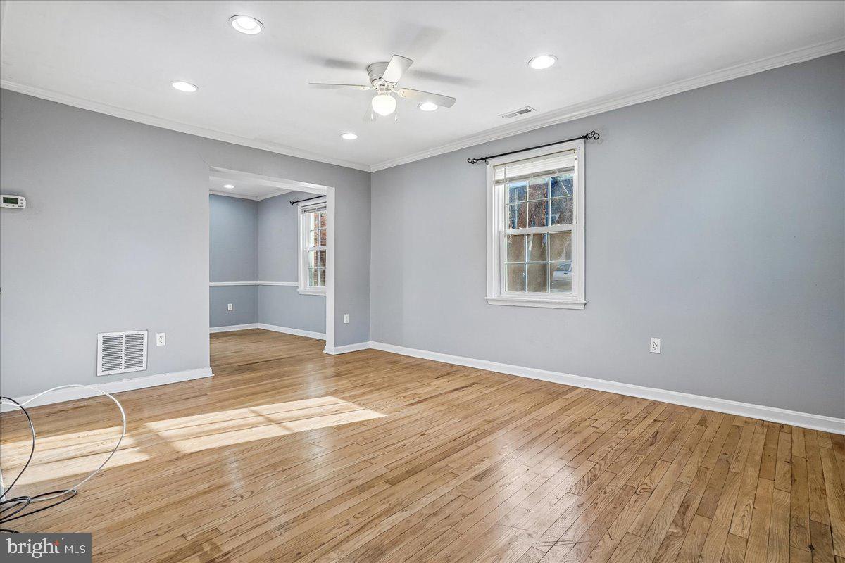 2015 38th Street Southeast, Unit B Washington, DC 20020 - Photo 5 of 30 an empty room with wooden floor and windows