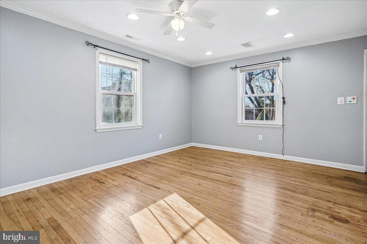 2015 38th Street Southeast, Unit B Washington, DC 20020 - Photo 6 of 30 a view of an empty room with a window and wooden floor