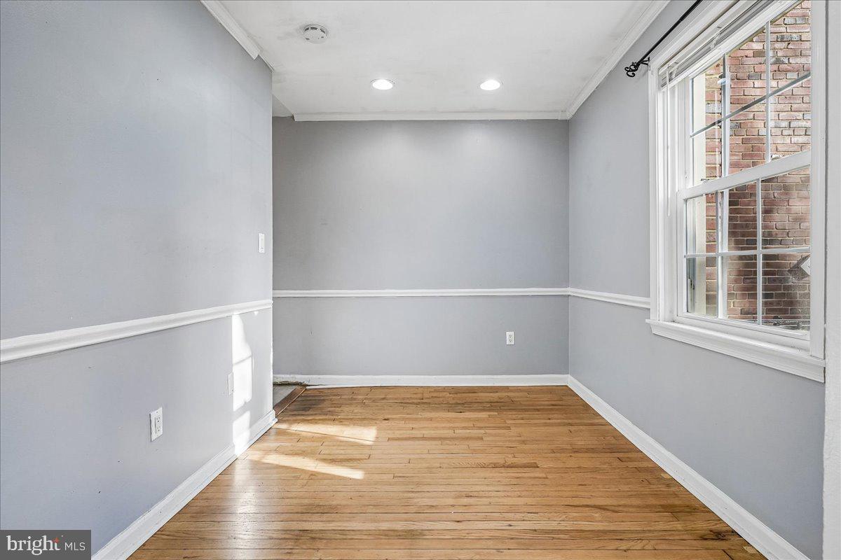 2015 38th Street Southeast, Unit B Washington, DC 20020 - Photo 10 of 30 a view of an empty room with wooden floor and a window