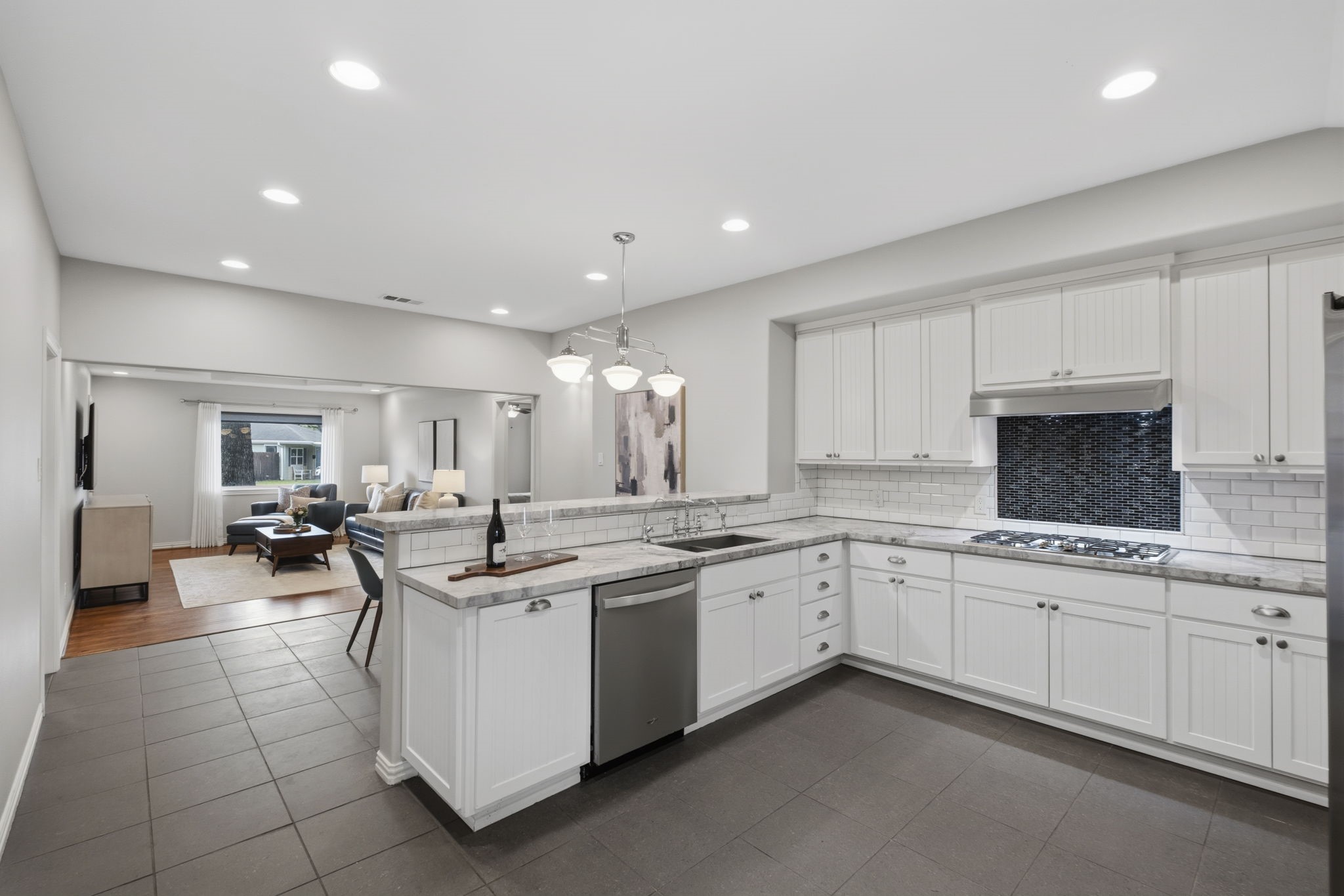 4733 Carleen Road Houston, TX 77092 - Photo 10 of 22 The oversized breakfast bar opens to the main living spaces, making entertaining feel effortless.
