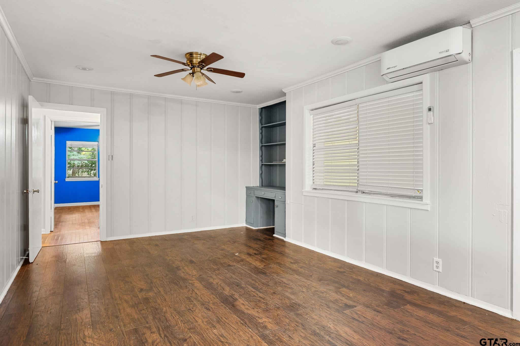 2811 Rollingwood Drive Tyler, TX 75701 - Photo 9 of 28 a view of empty room with wooden floor and ceiling fan