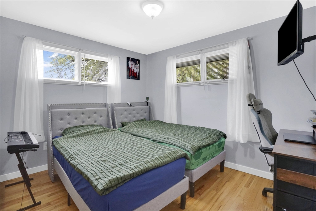 94 Cora Avenue Chicopee, MA 01013 - Photo 26 of 41 a bedroom with a bed a mirror on desk and a window