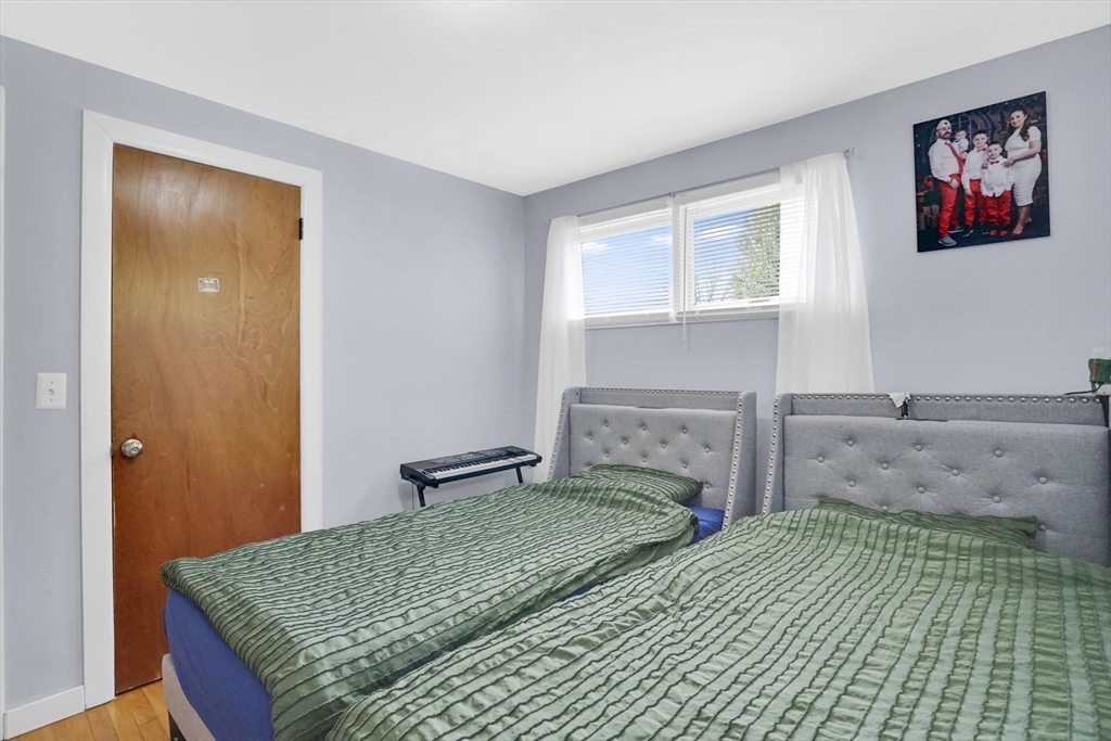 94 Cora Avenue Chicopee, MA 01013 - Photo 27 of 41 a bedroom with a bed and a fireplace