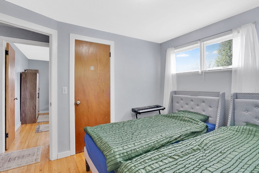 94 Cora Avenue Chicopee, MA 01013 - Photo 28 of 41 a bedroom with a bed and a mirror