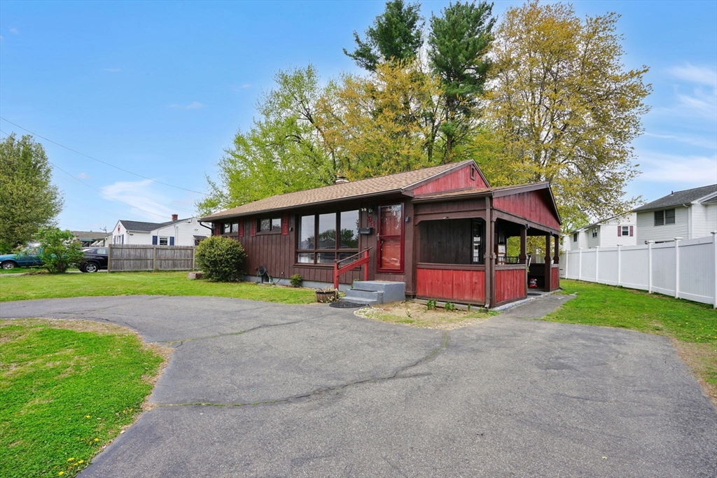 94 Cora Avenue Chicopee, MA 01013 - Photo 3 of 41 a view of a house with a yard and sitting area