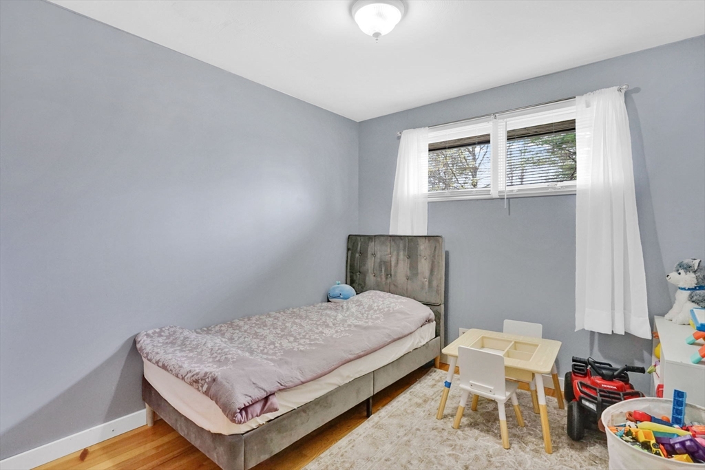 94 Cora Avenue Chicopee, MA 01013 - Photo 32 of 41 a bedroom with a bed and chair