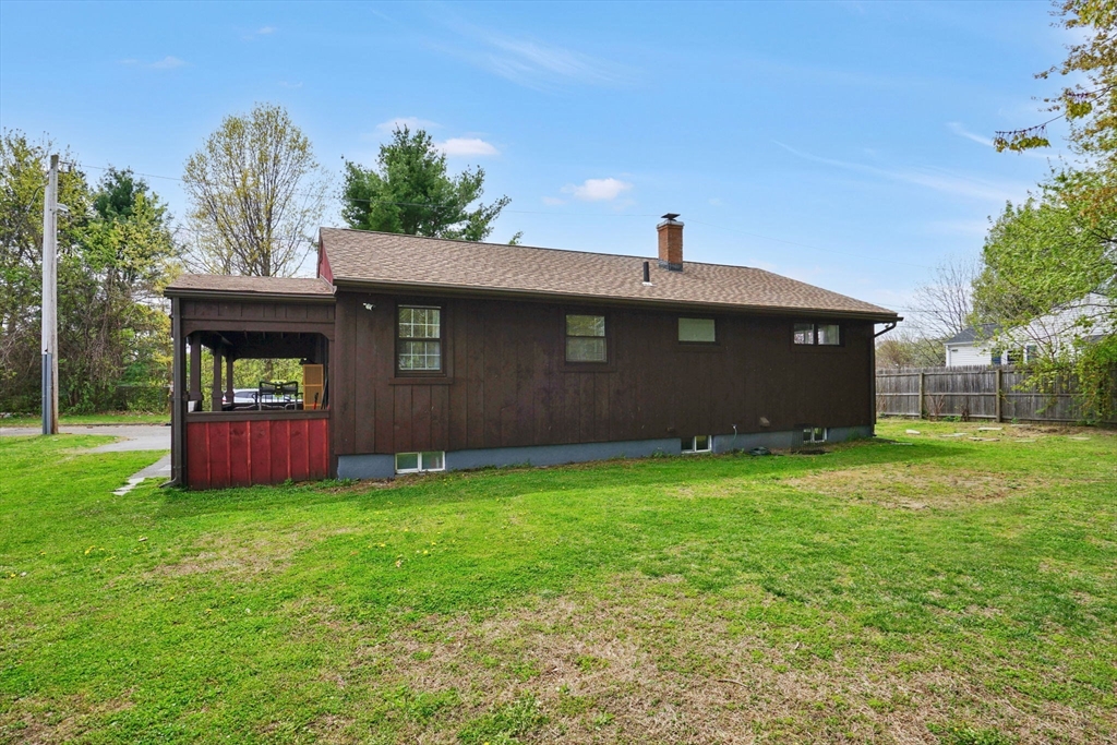 94 Cora Avenue Chicopee, MA 01013 - Photo 7 of 41 a front view of a house with a garden and yard