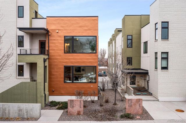 a front view of a house with large windows