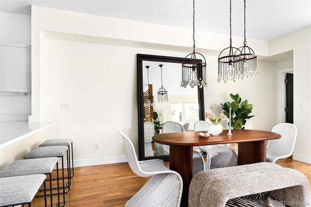 a dining room with furniture and wooden floor