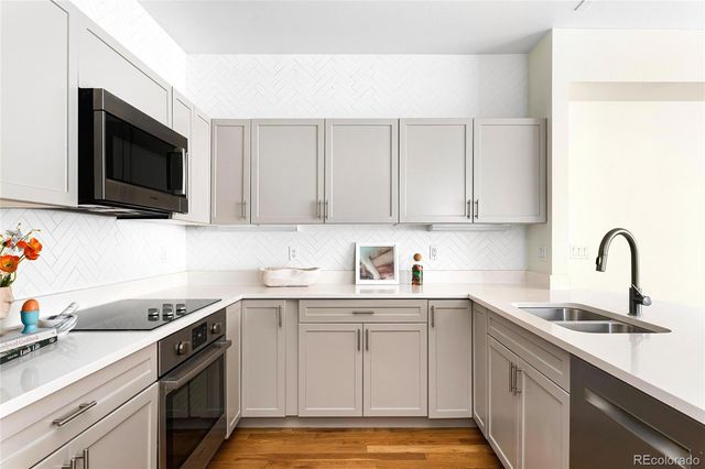 a kitchen with a sink stove and microwave